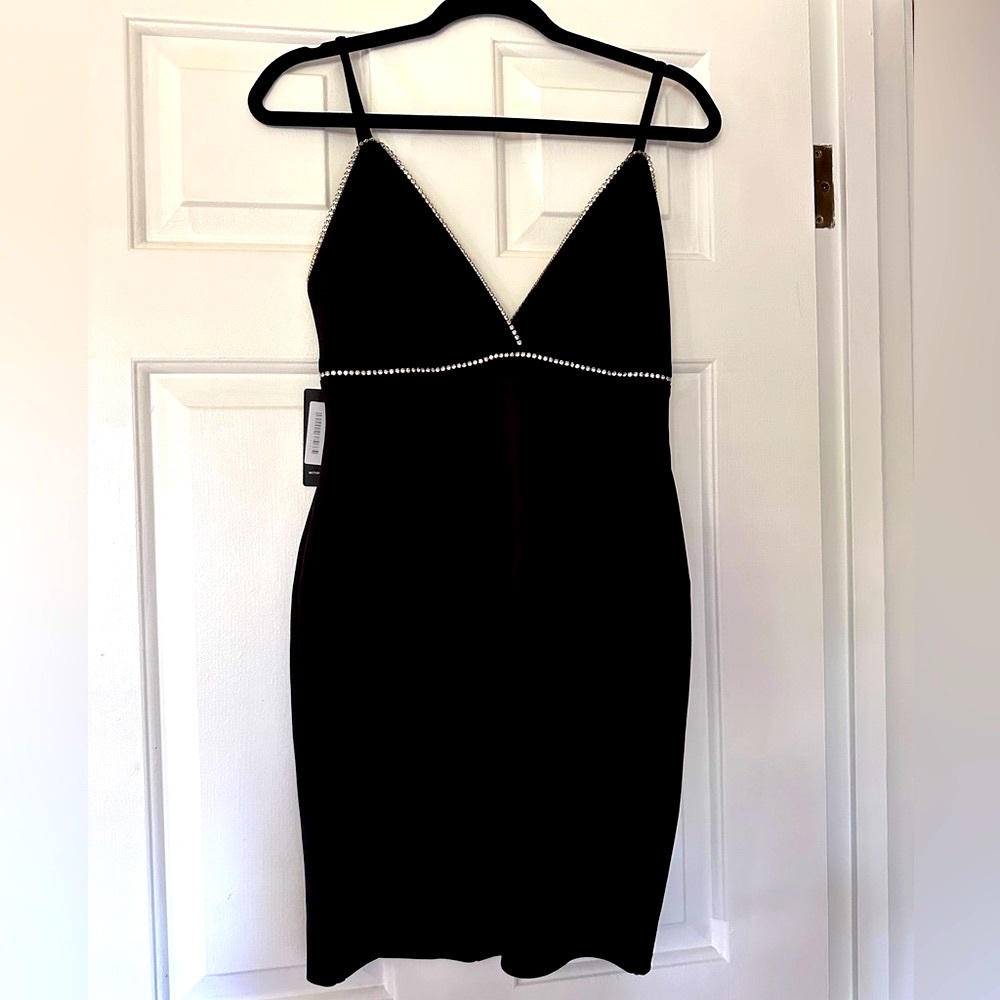 Brand new with tags Lovely Day little black dress with rhinestones. Size medium.
